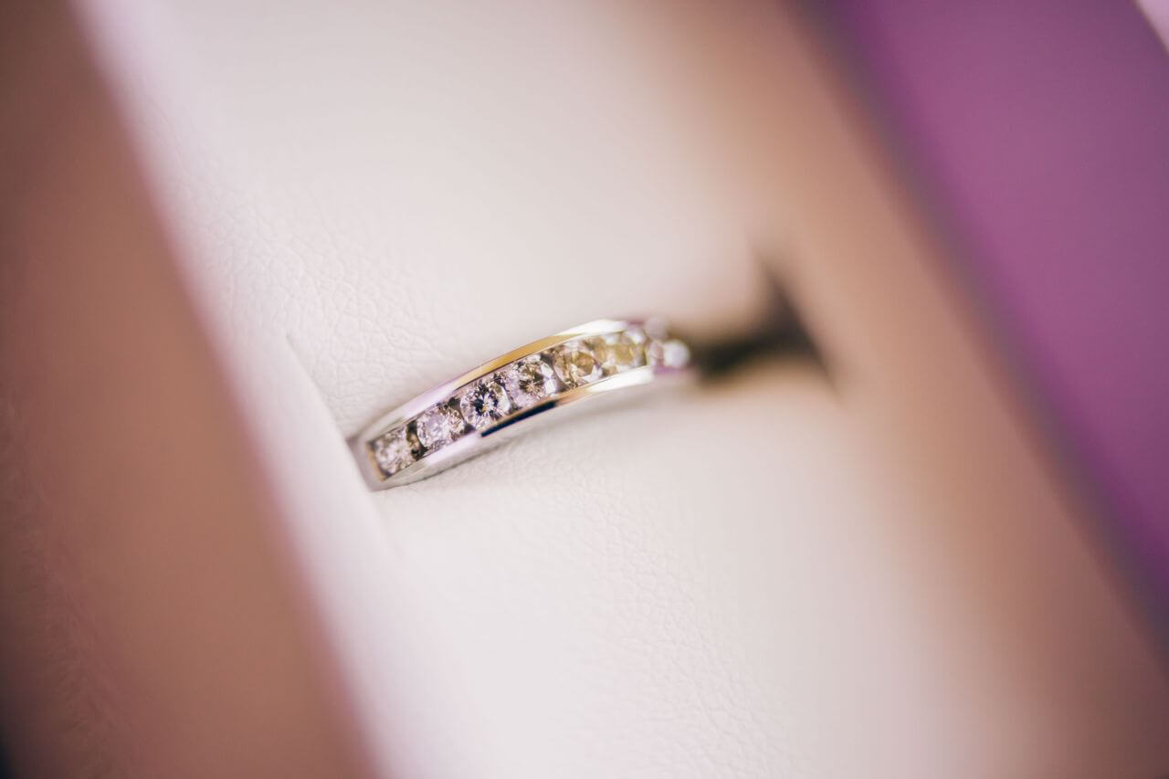 a white gold channel diamond wedding band in a ring box