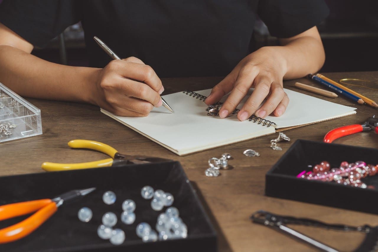 woman designing jewelry