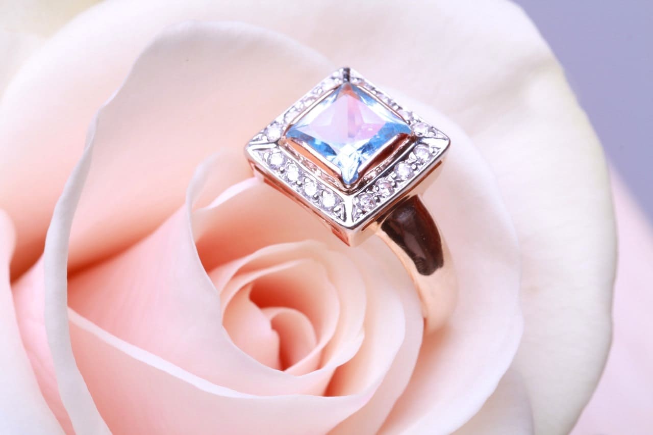 An engagement ring with a princess cut diamond center stone