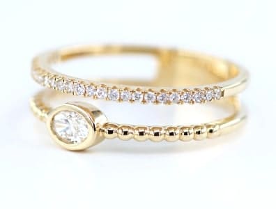 A gold diamond fashion ring from ELIE AZZI.