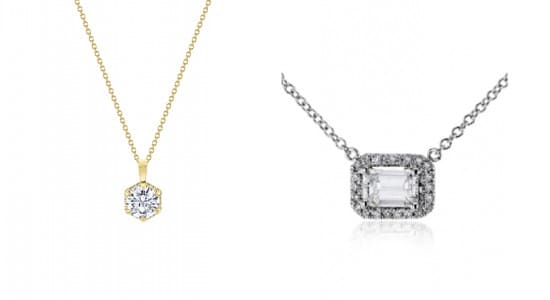 a yellow gold diamond pendant necklace next to a white gold diamond pendant necklace featuring an emerald cut diamond