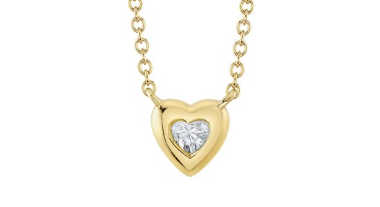 a yellow gold heart shape pendant necklace featuring a heart shaped diamond